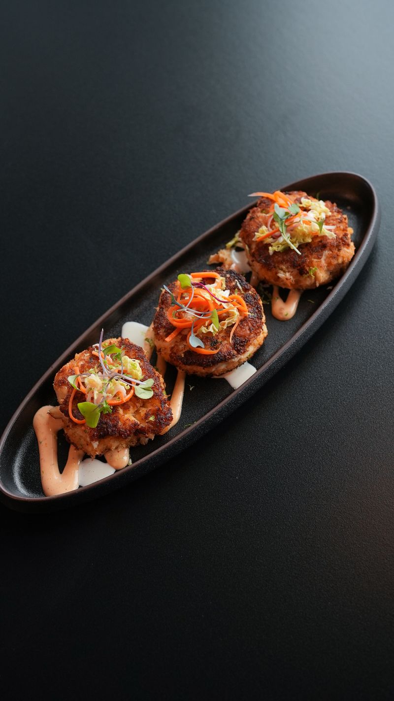 Jumbo lump crab cakes with daikon slaw and spicy yuzu aioli