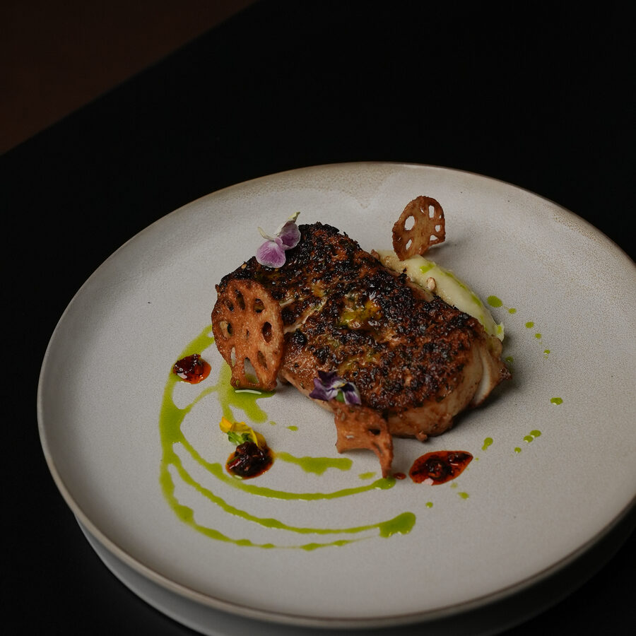 Seared filet with sauce and greens