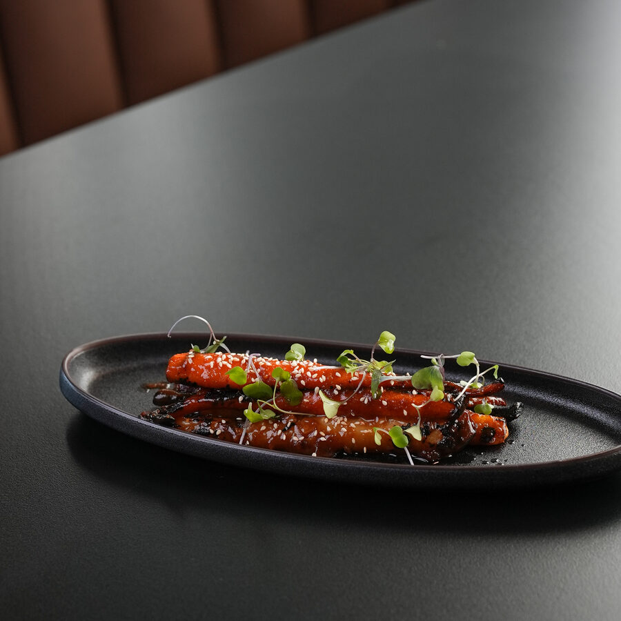 Assorted nigiri on a long slate plate