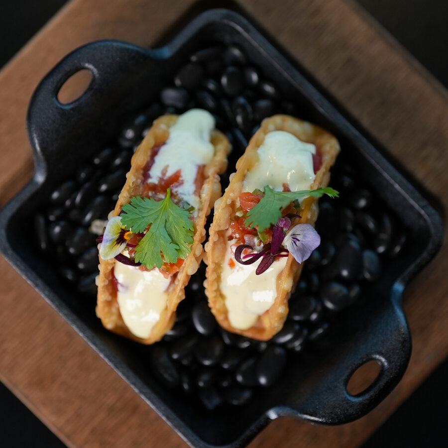 Sashimi tacos on a black stone plate