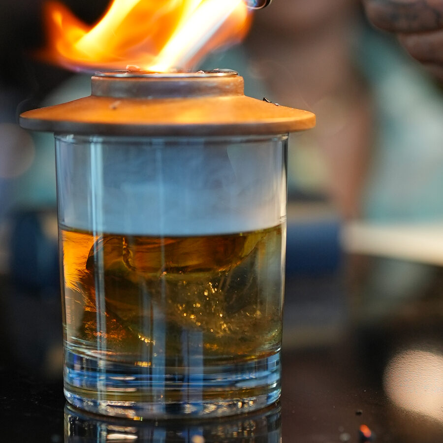 A smoking craft cocktail presentation